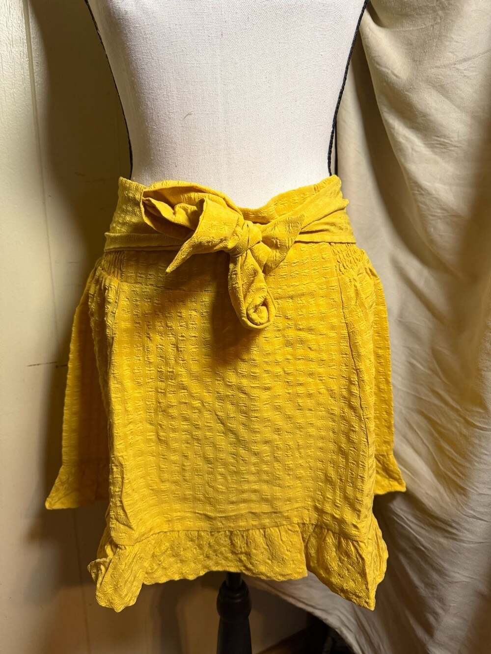 Promesa Mustard Yellow Textured Mini Skirt with Tie Waist and Ruffle Hem